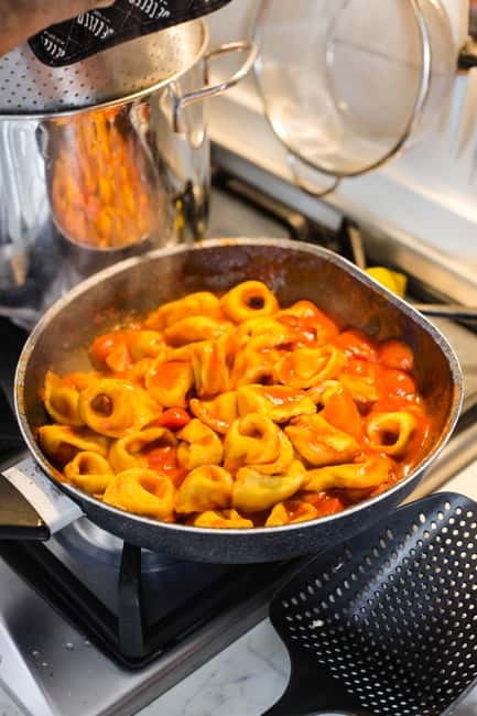 Bologna: 3 Pastas, Tiramisu and Unlimited Wine Tasting - Arriving with pizza, wine, and a friendly welcome