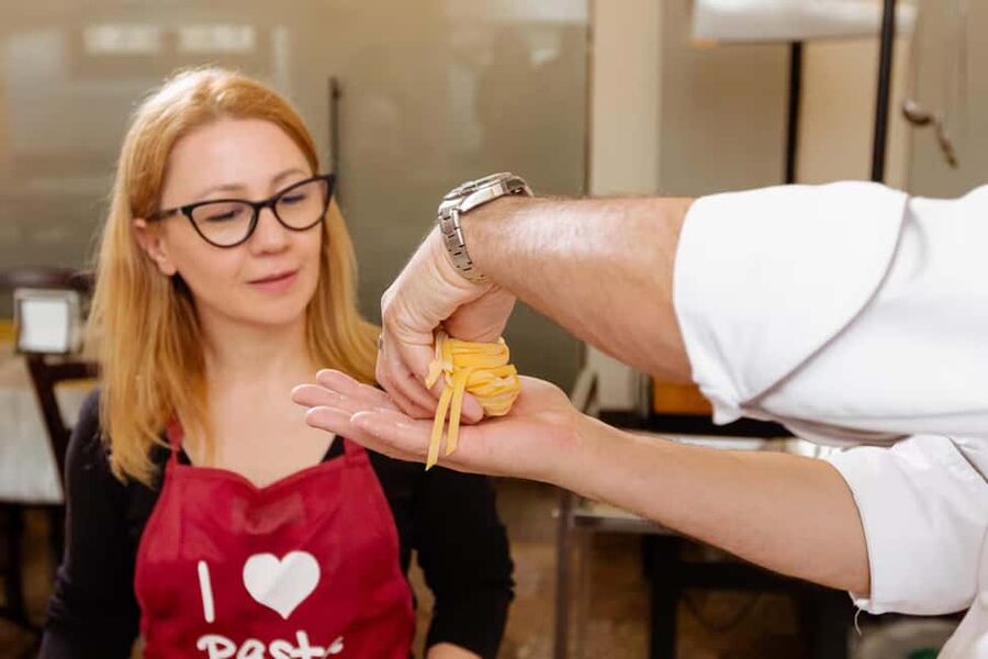 Florence: Pasta Class with Wine, Limoncello and Dessert - Making pasta beside Ponte Vecchio