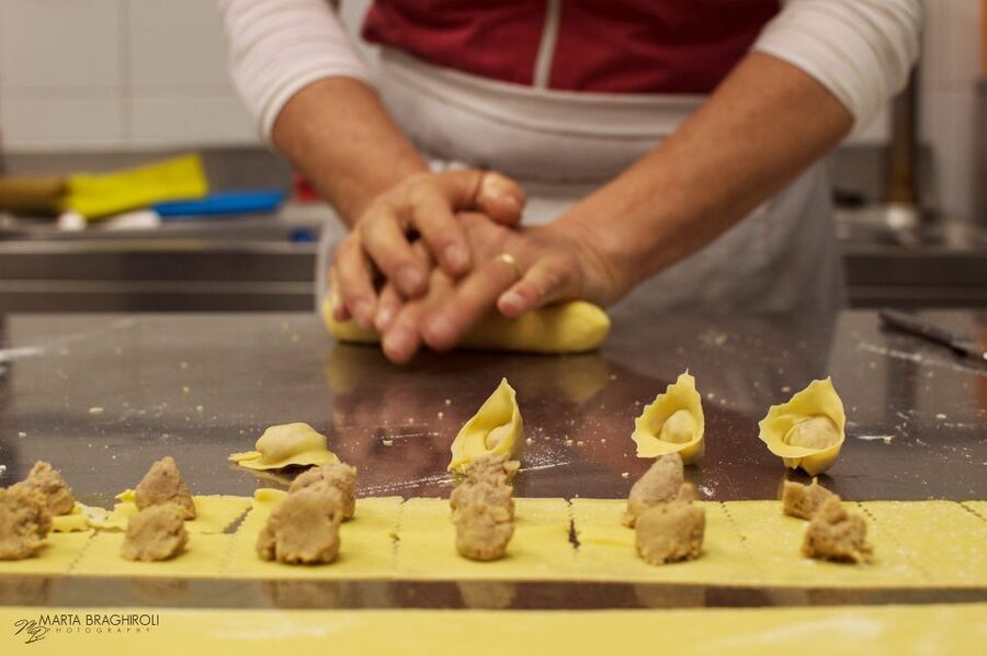 Verona: Tortellini Cooking Class and Lunch with Mamma Ivana - Filling and shaping the tortellini love knot